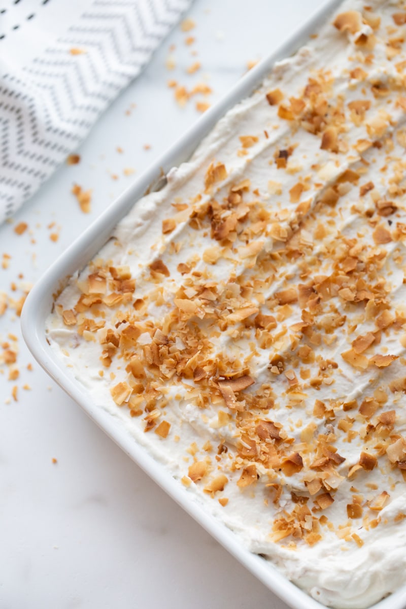 coconut sheet cake in a sheet pan