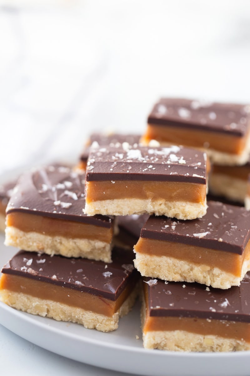 several pieces of millionaire shortbread stacked on a platter
