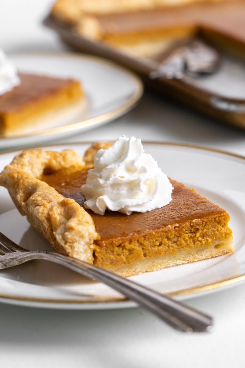 slice of pumpkin slab pie on plate with whipped cream