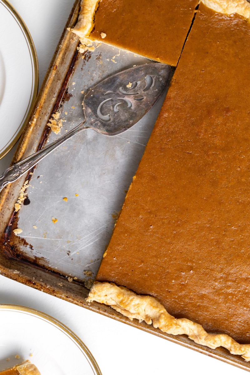 pumpkin slab pie in the pan with slices cut out