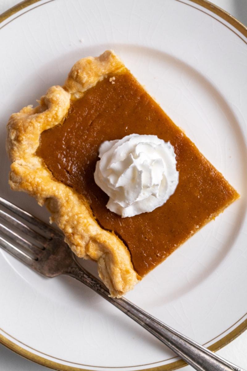 slice of pumpkin pie with whipped cream