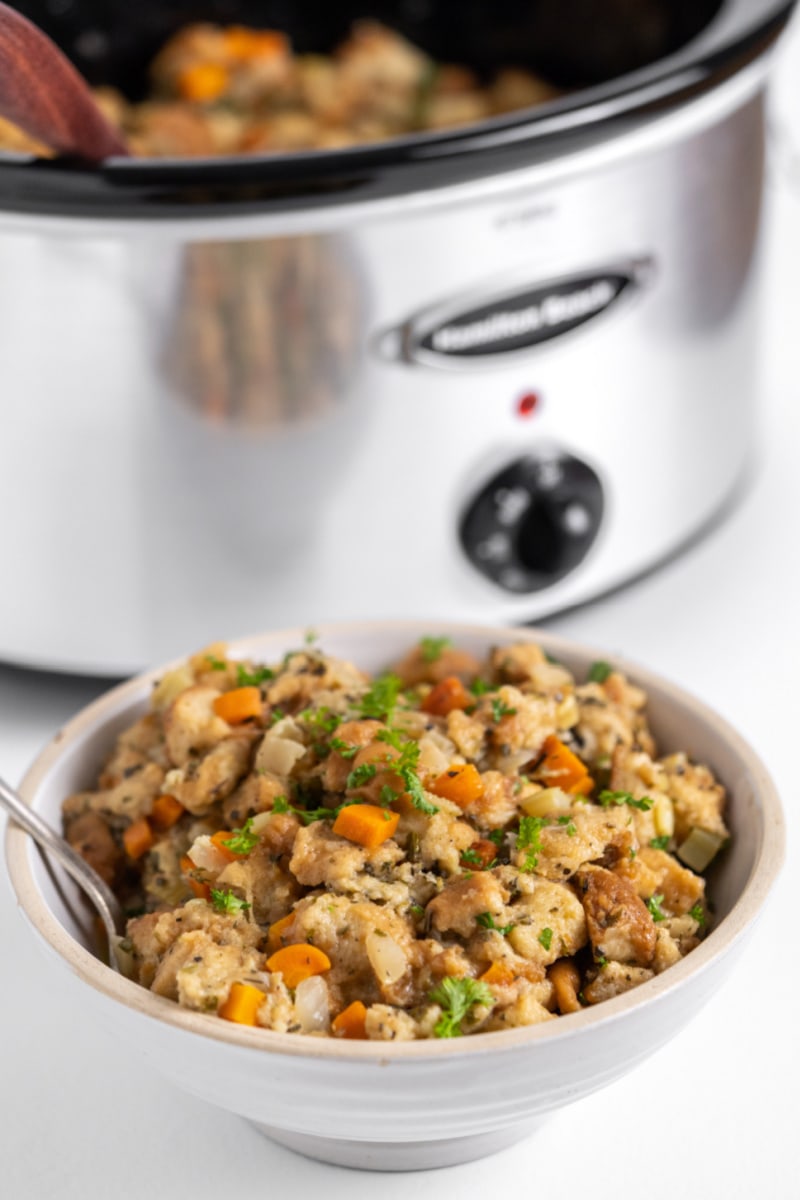 stuffing in a bowl slow cooker in background