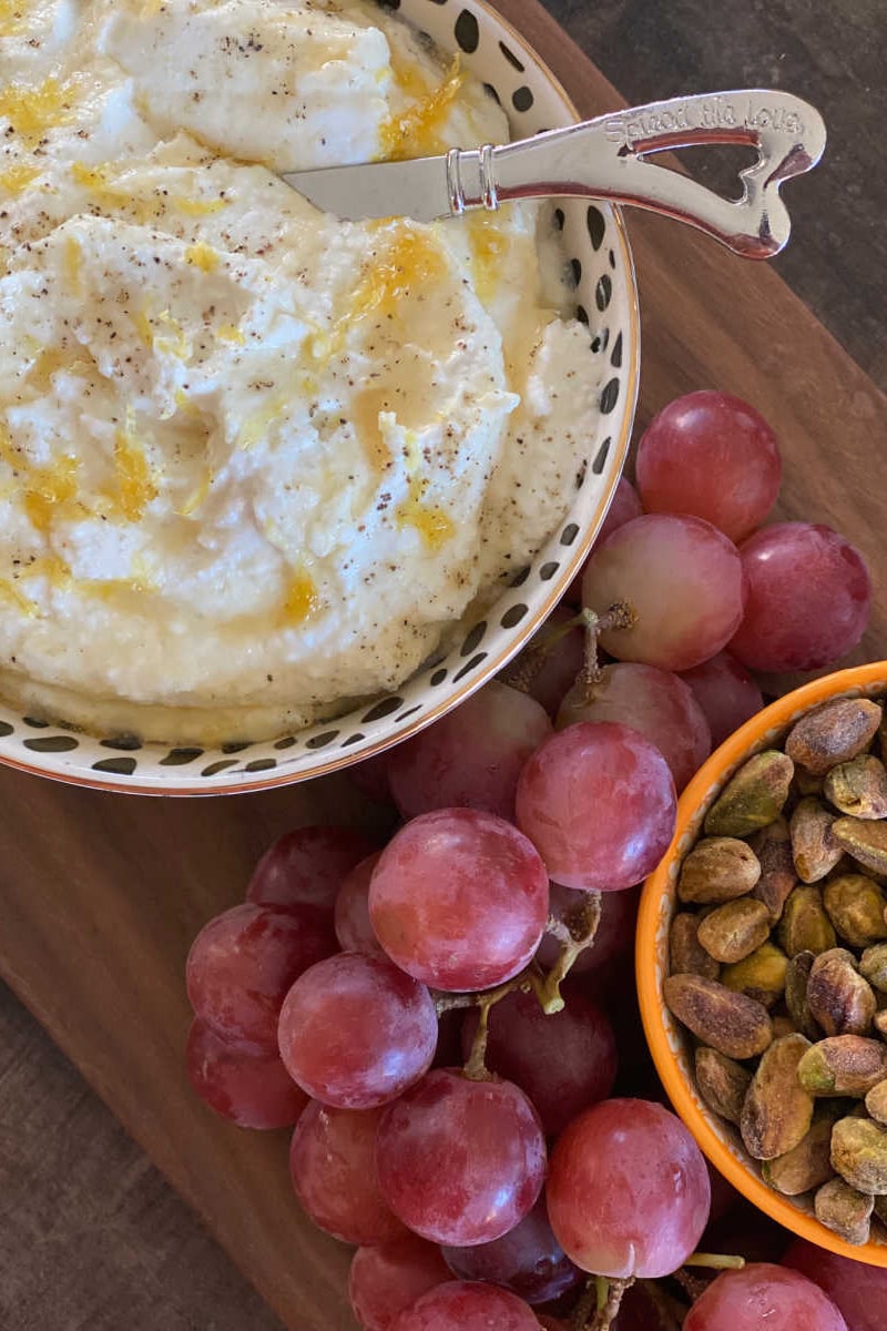 whipped goat cheese and ricotta dip with grapes and pistachios