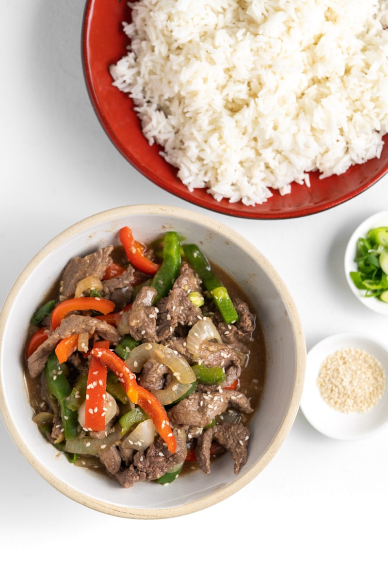 pepper steak in bowl and rice in bowl