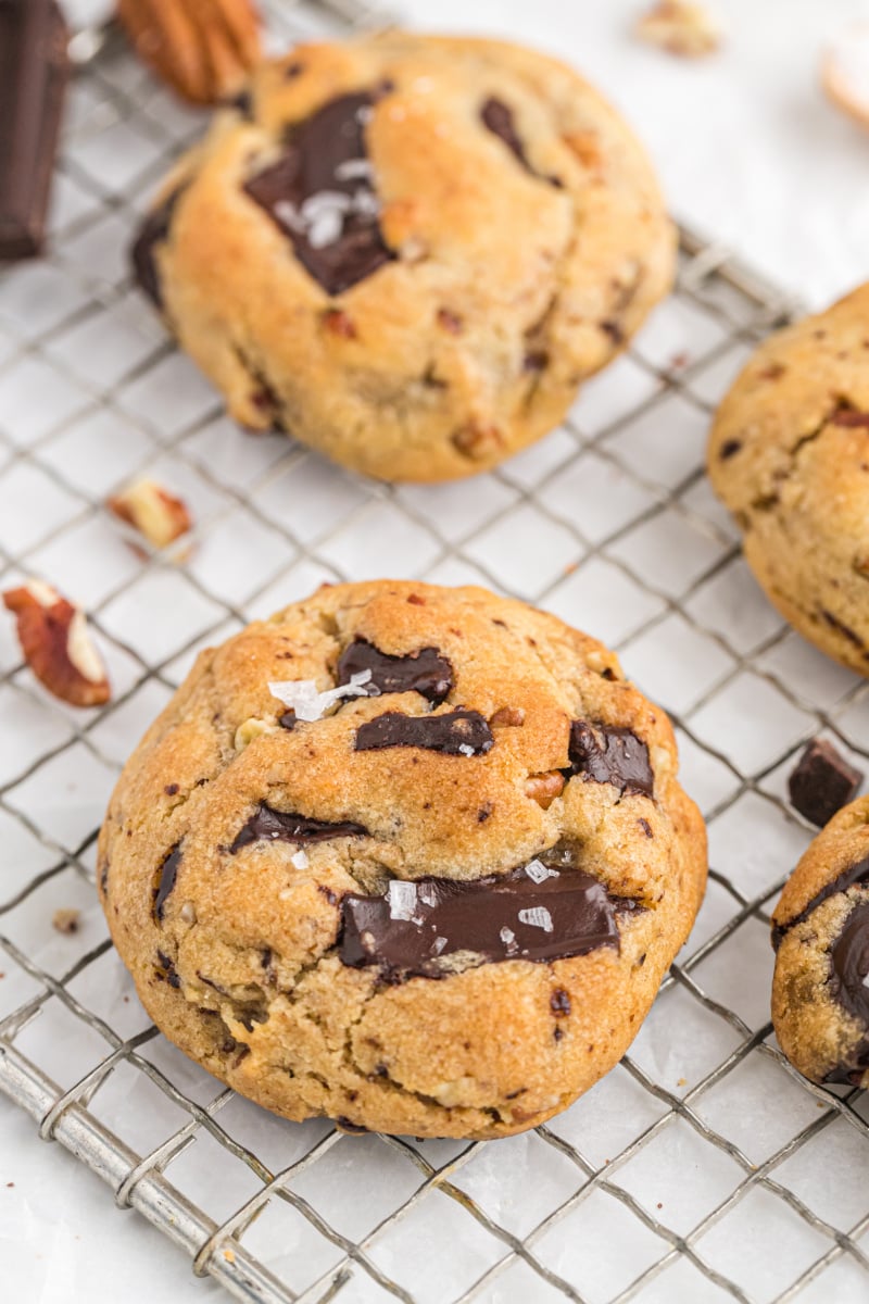 brown butter pecan chocolate chip cookies on a cooling rack