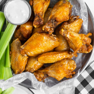 plate of buffalo wings with celery and blue cheese dressing