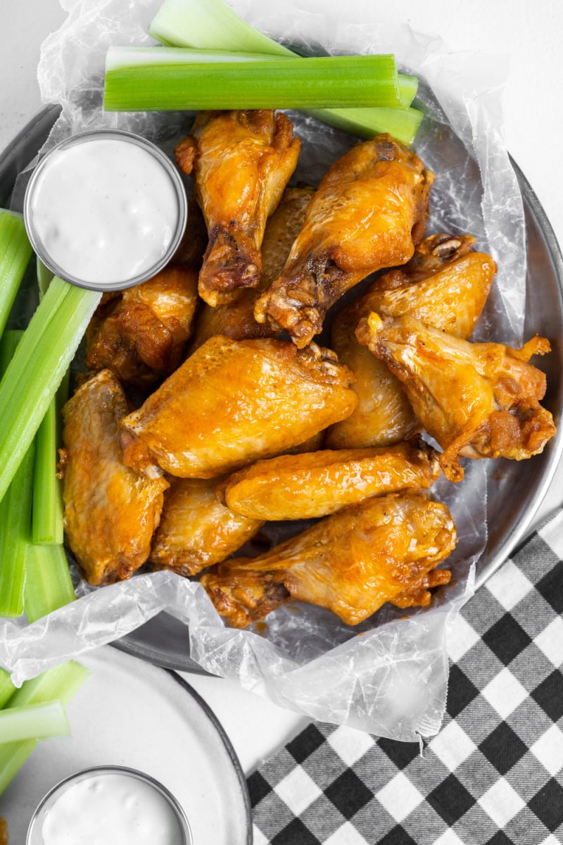 plate of buffalo wings with celery and blue cheese dressing