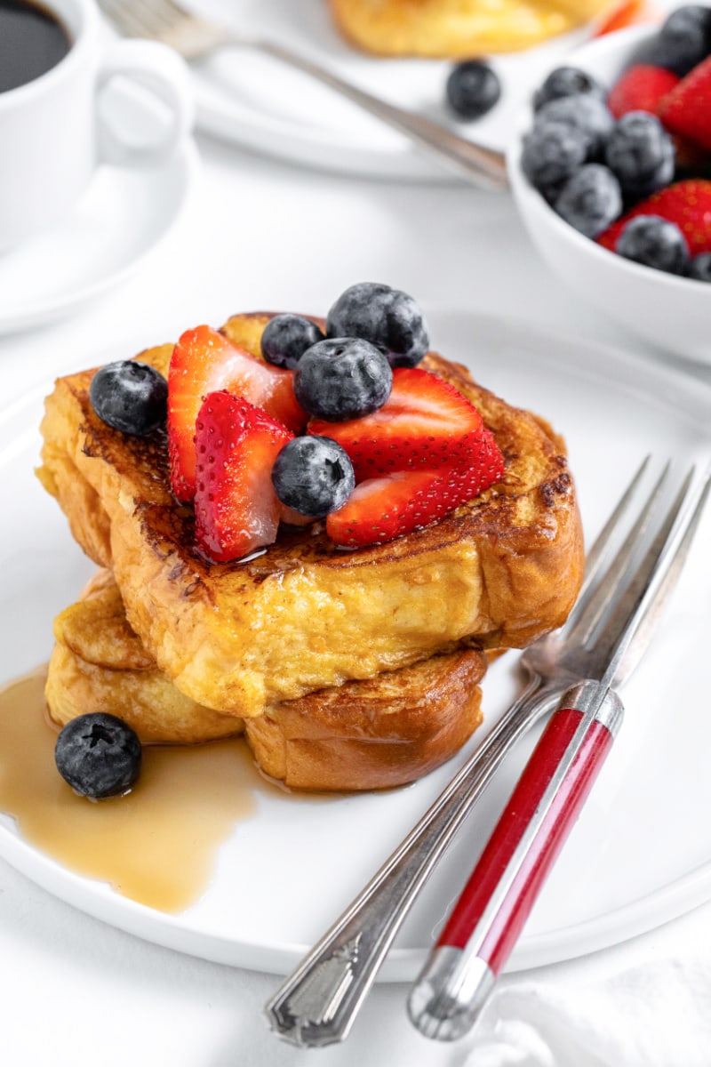french toast topped with berries and syrup