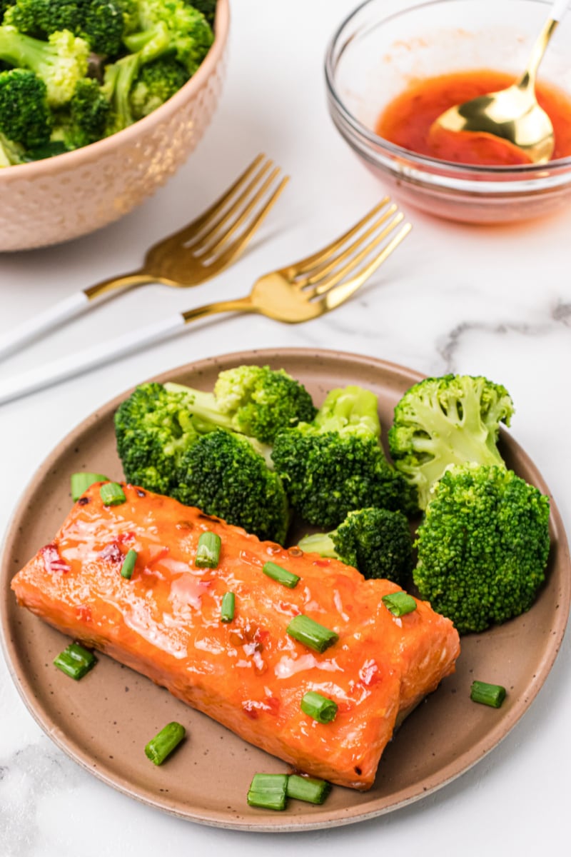 sweet and spicy air fryer salmon on a plate with broccoli