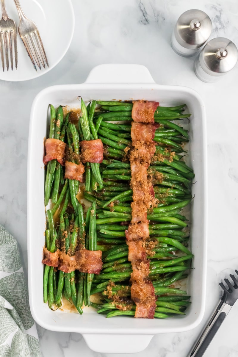 bacon wrapped green beans baked in a baking dish