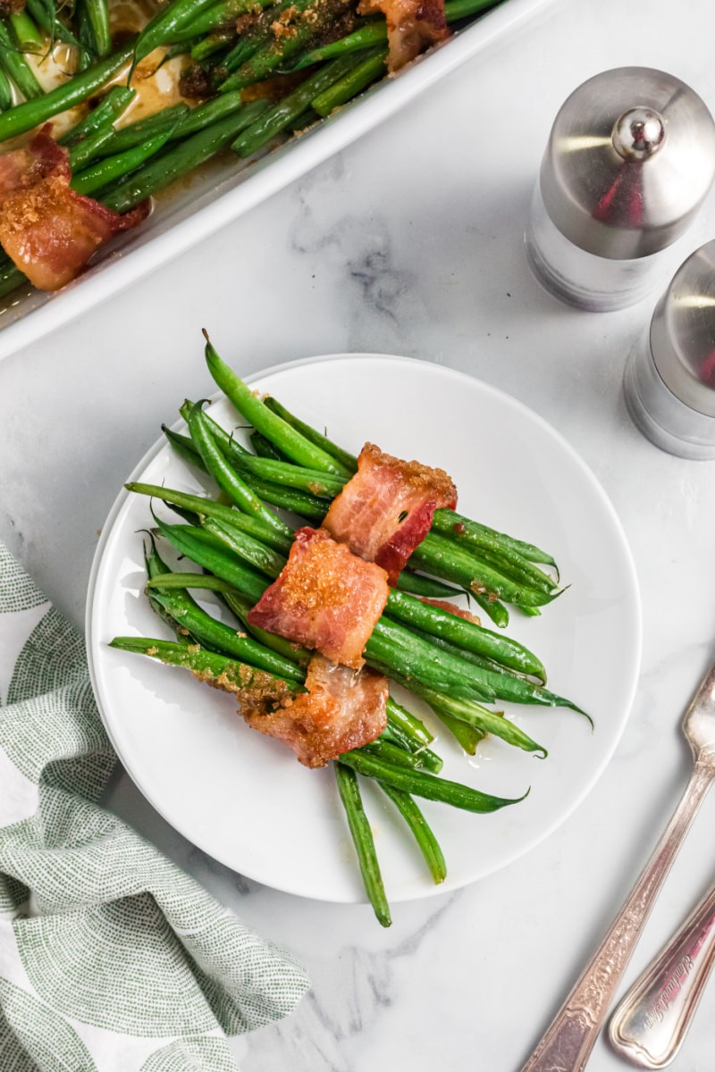 bacon wrapped green bean bundles on a white plate