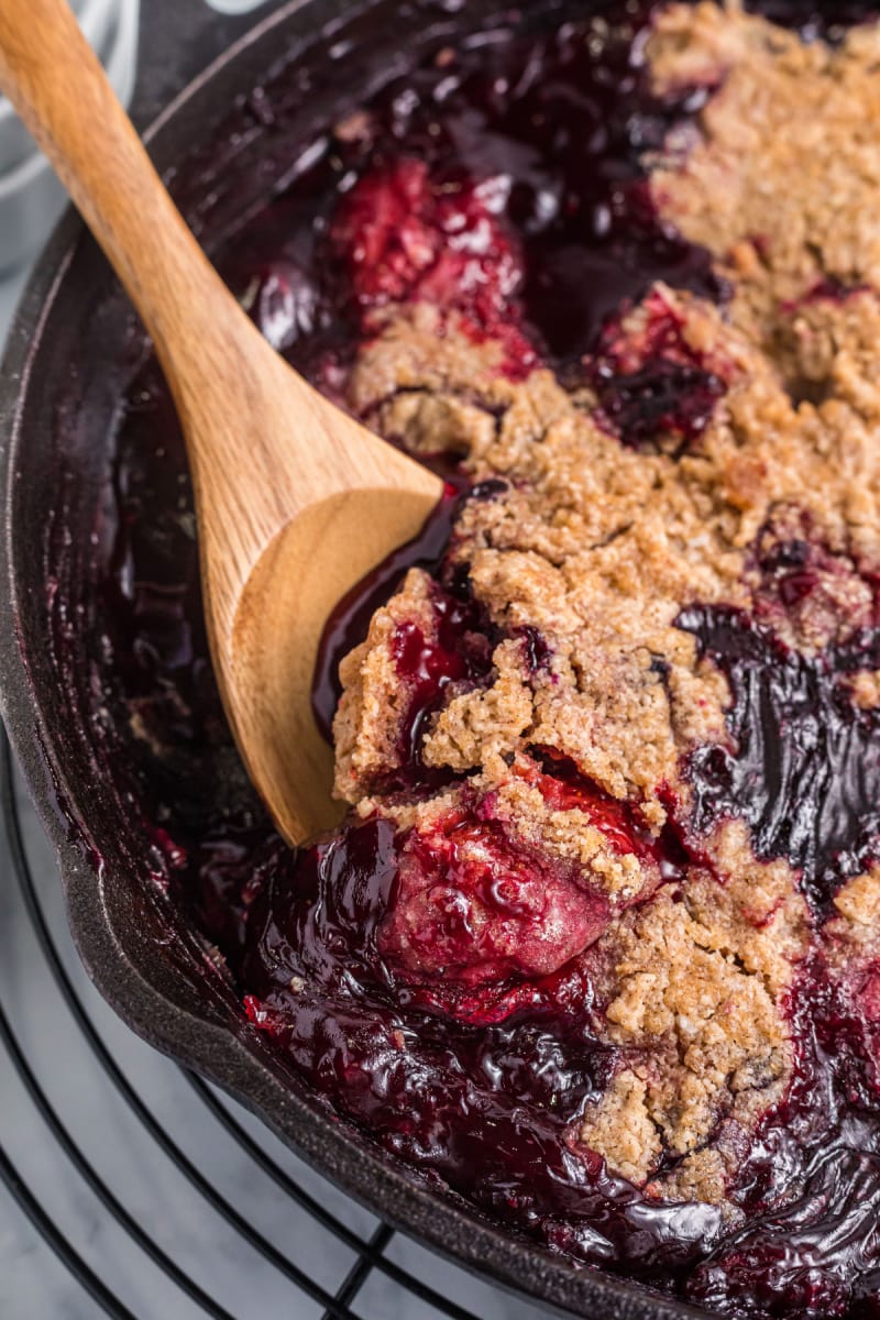 pan of berry crumble with wooden spoon in it