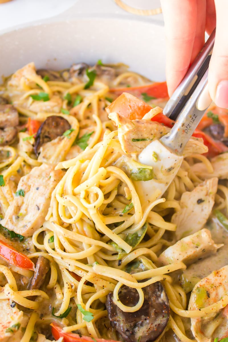 tongs taking pasta out of pot