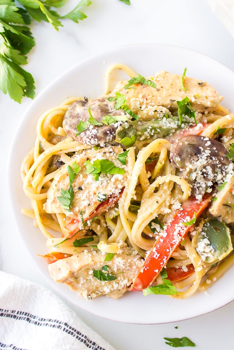 serving of cajun chicken pasta on a white plate