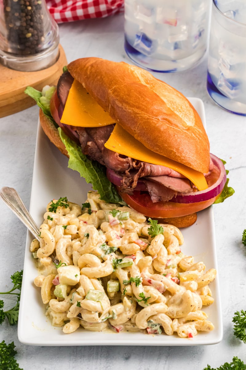 serving of macaroni salad on a plate with sandwich