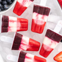 red white and blueberry popsicles over ice