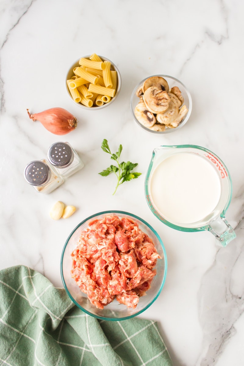 ingredients displayed for making creamy sausage mushroom rigatoni