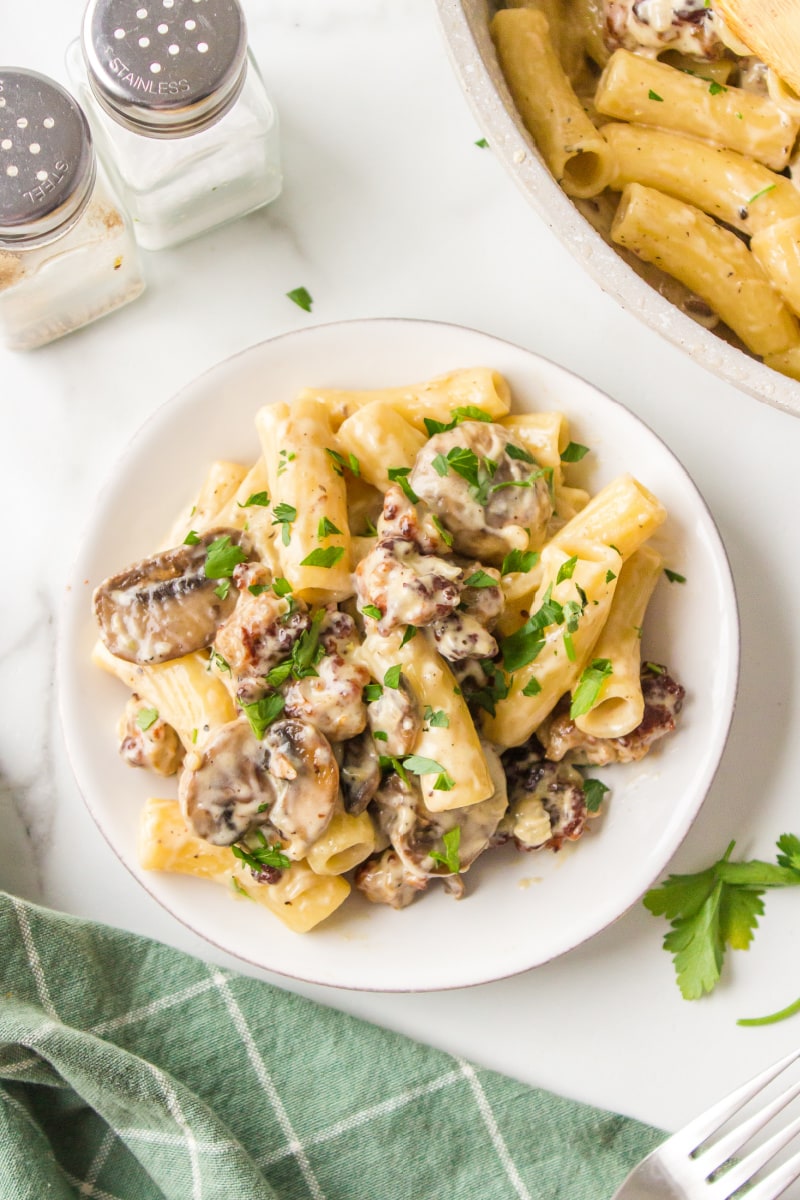 serving of creamy sausage mushroom rigatoni on white plate