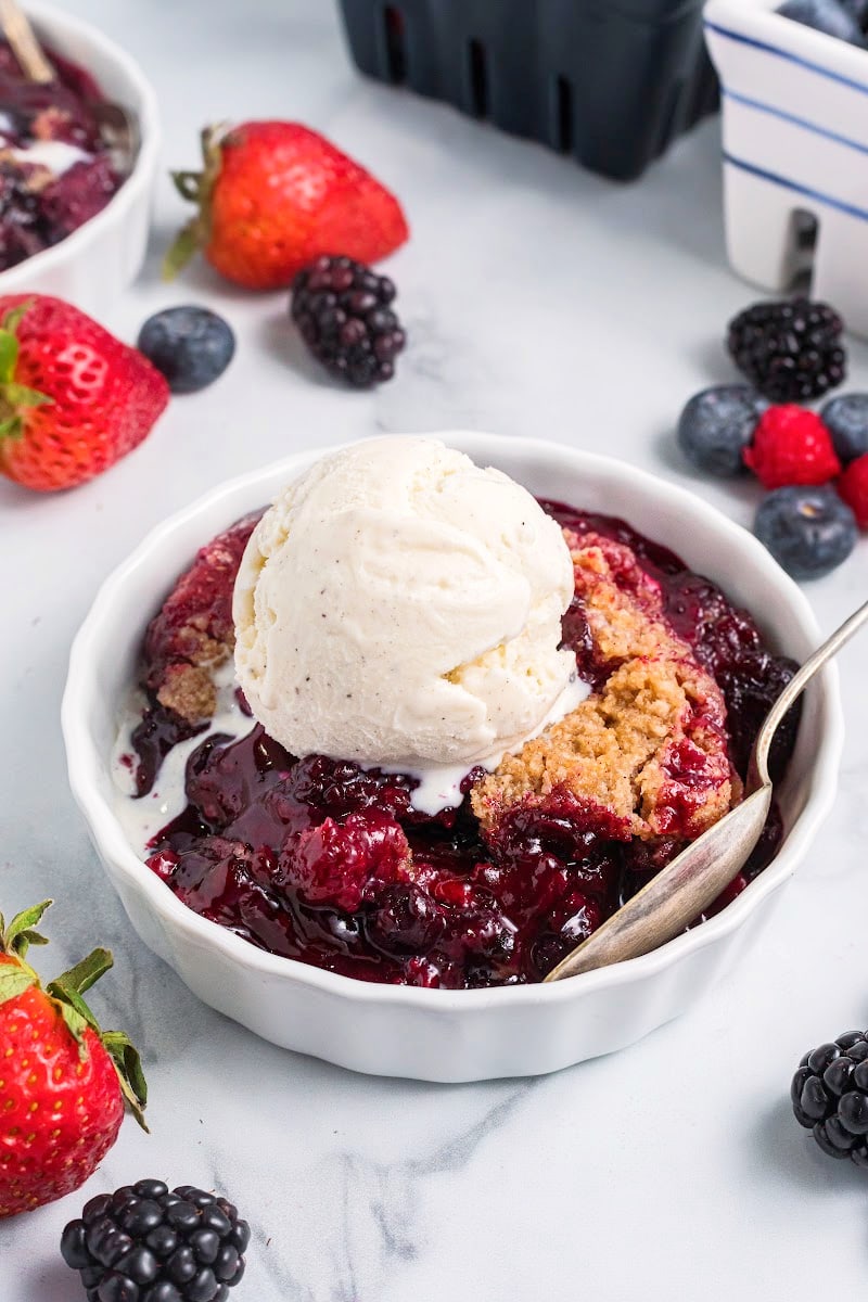 berry crumble in a dish with ice cream