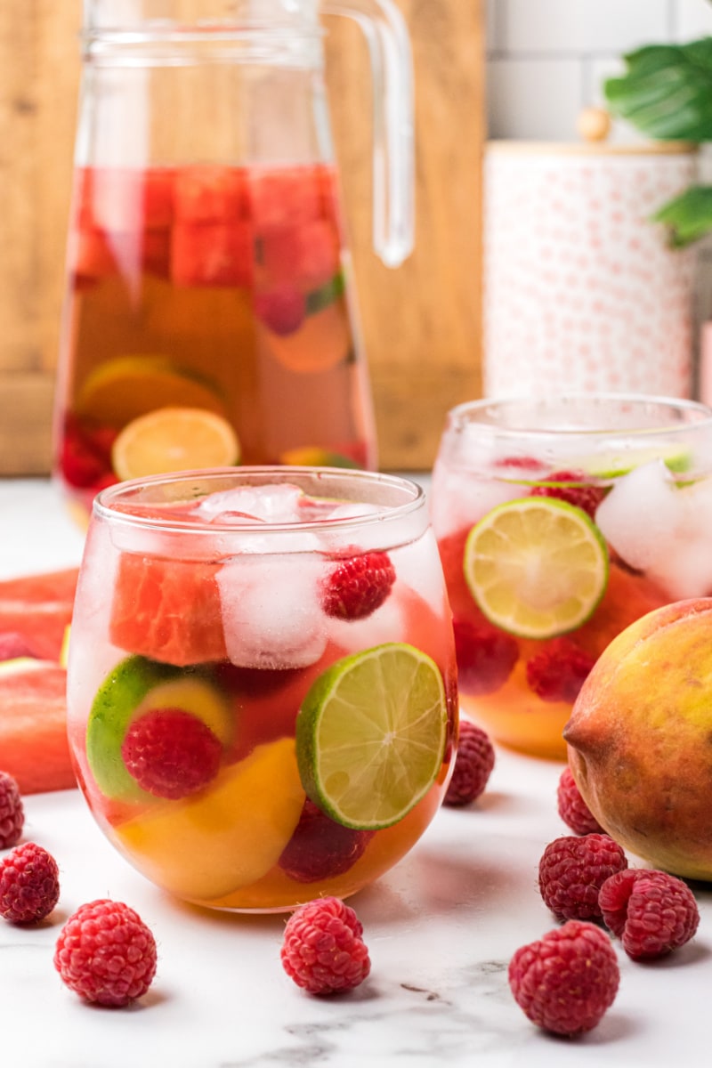 glasses of rose sangria with pitcher in background