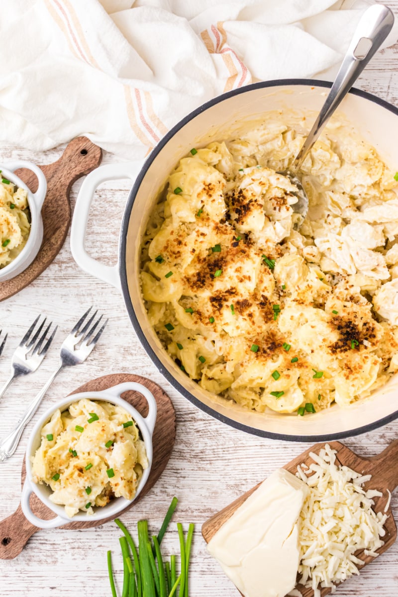 pot of tortellini mac and cheese with individual servings