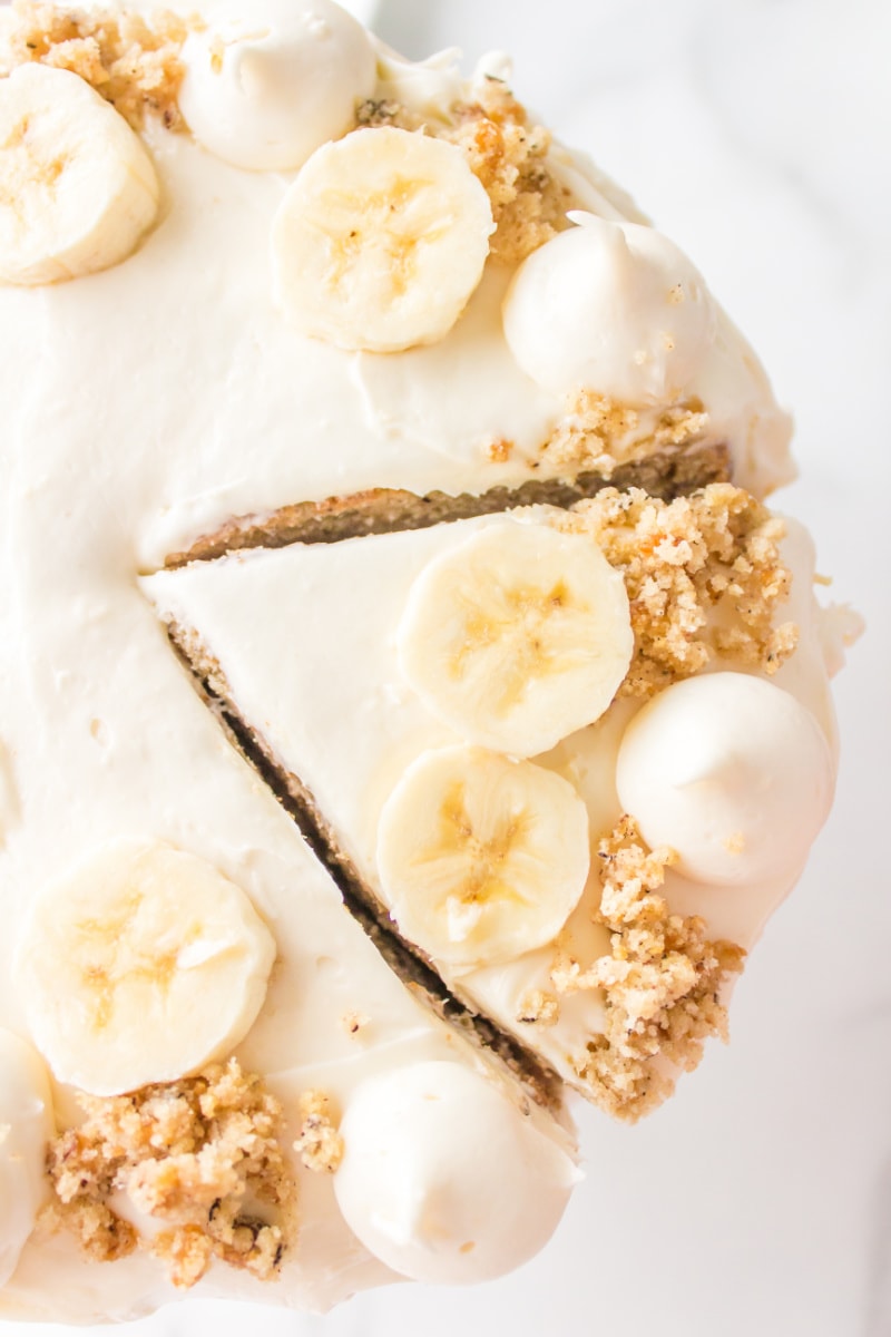 overhead shot of banana cheesecake cake sliced into