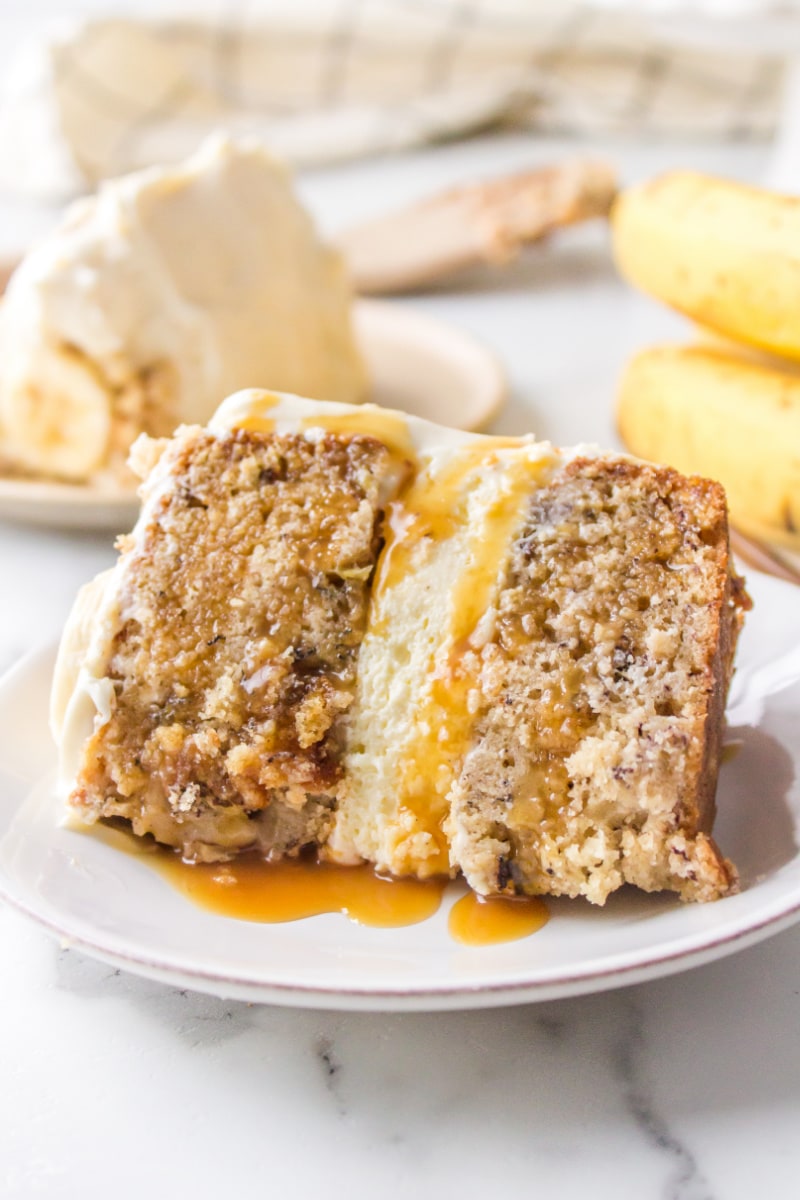 slice of banana cheesecake cake with caramel sauce