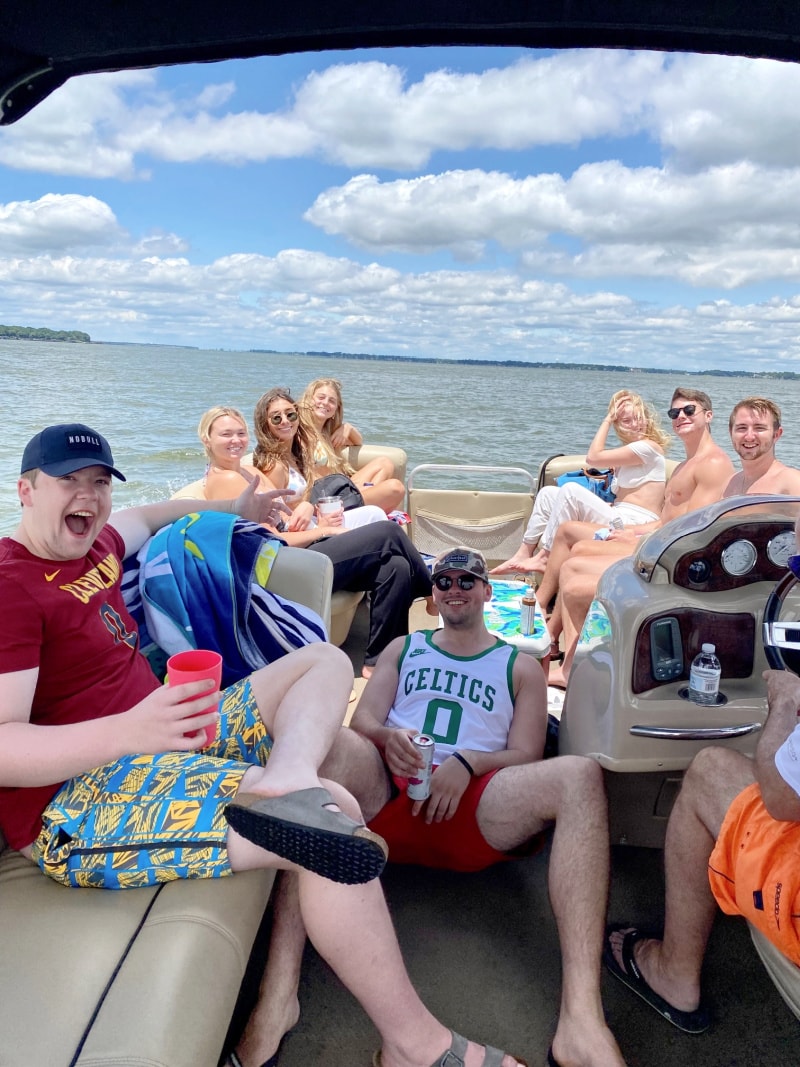 college kids on a pontoon boat