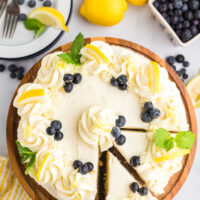 overhead shot of blueberry cheesecake cake with a couple of slices cut