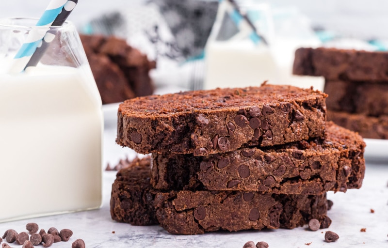 three slices of chocolate zucchini bread with a glass of milk