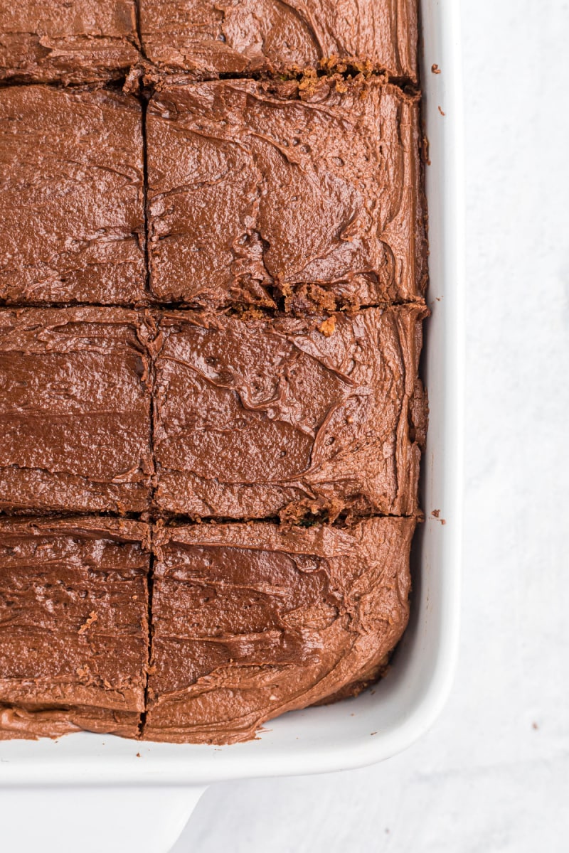 chocolate zucchini brownie cake in a baking dish sliced into pieces