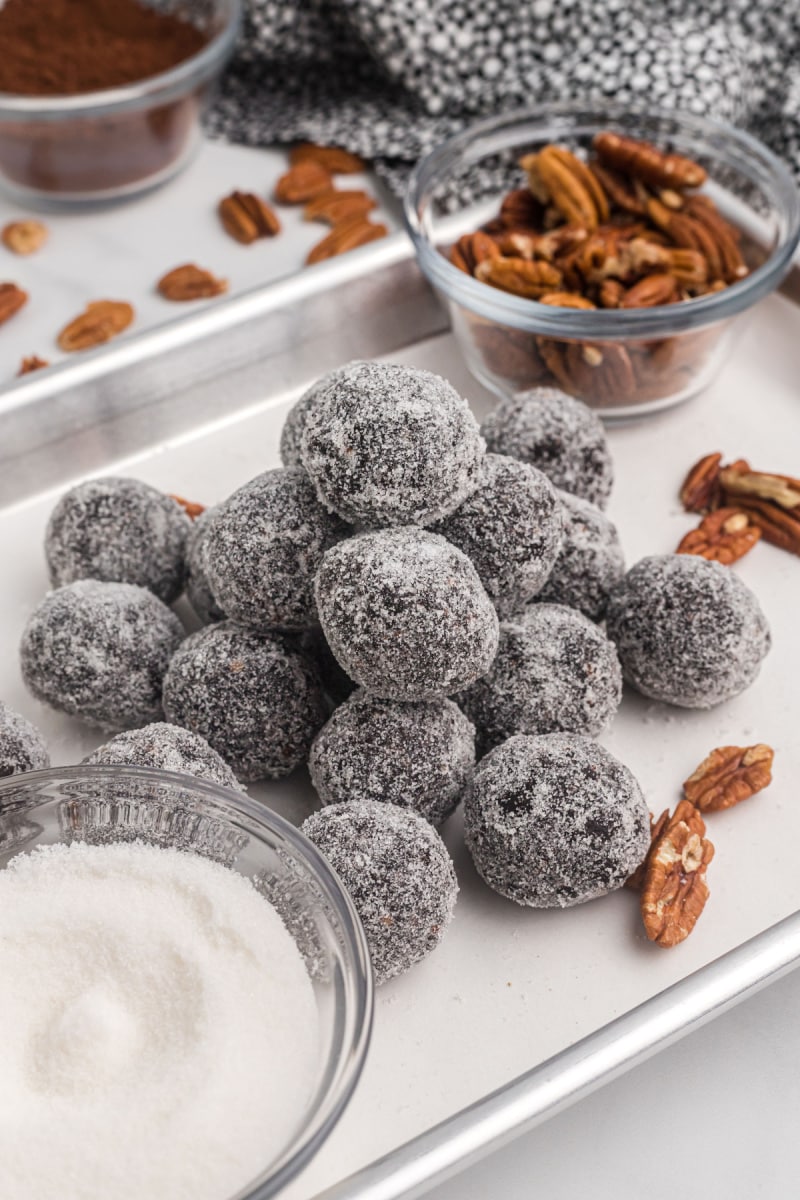 bourbon balls piled on a baking sheet