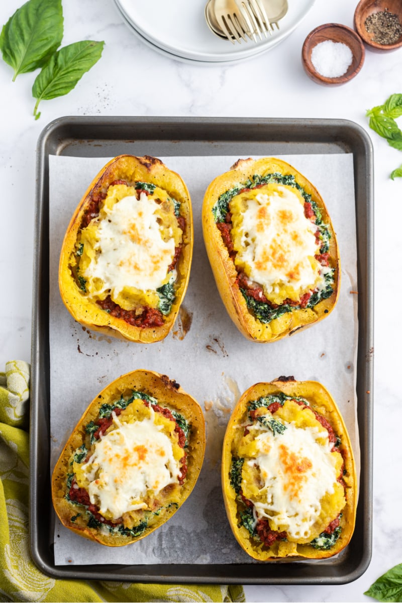 four cheesy lasagna boats on baking sheet