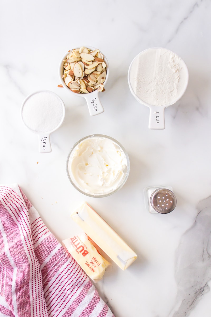 ingredients displayed for making almond cream cheese snowball cookies