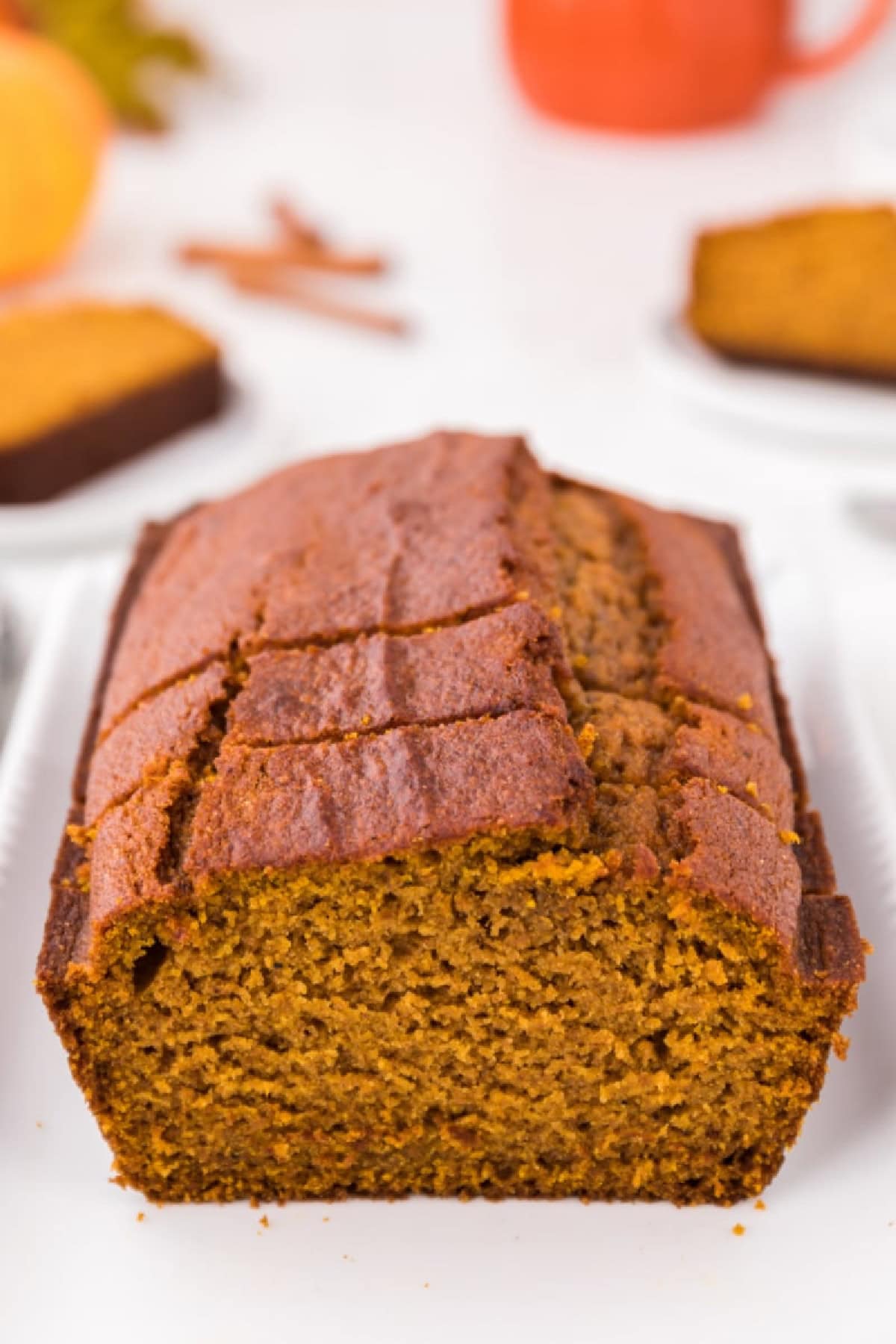 This moist Whole Wheat Pumpkin Bread is made with olive oil, pumpkin puree, whole wheat flour, cinnamon, nutmeg and warm fall spices. It's an easy pumpkin bread recipe for breakfast, snacking, freezing or fall gifting. whole wheat pumpkin bread loaf sliced