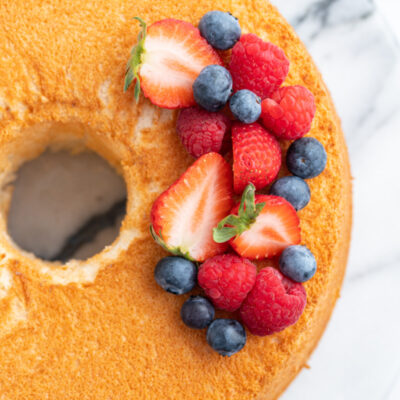 overhead shot of angel food cake with fresh berries on top