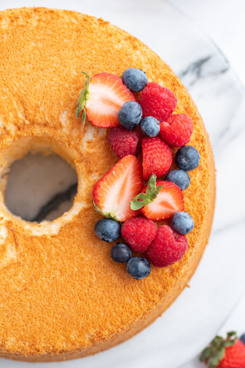 overhead shot of angel food cake with fresh berries on top