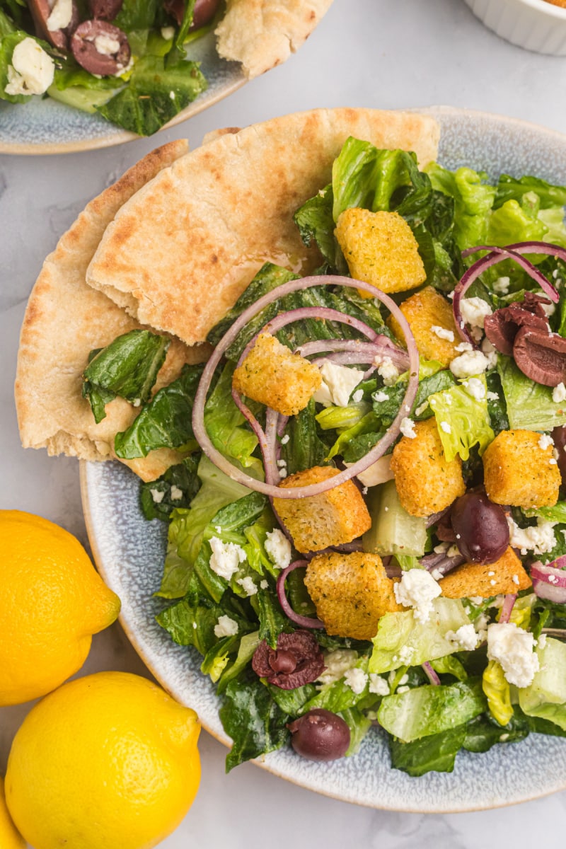 plate of greek caesar salad with pita bread