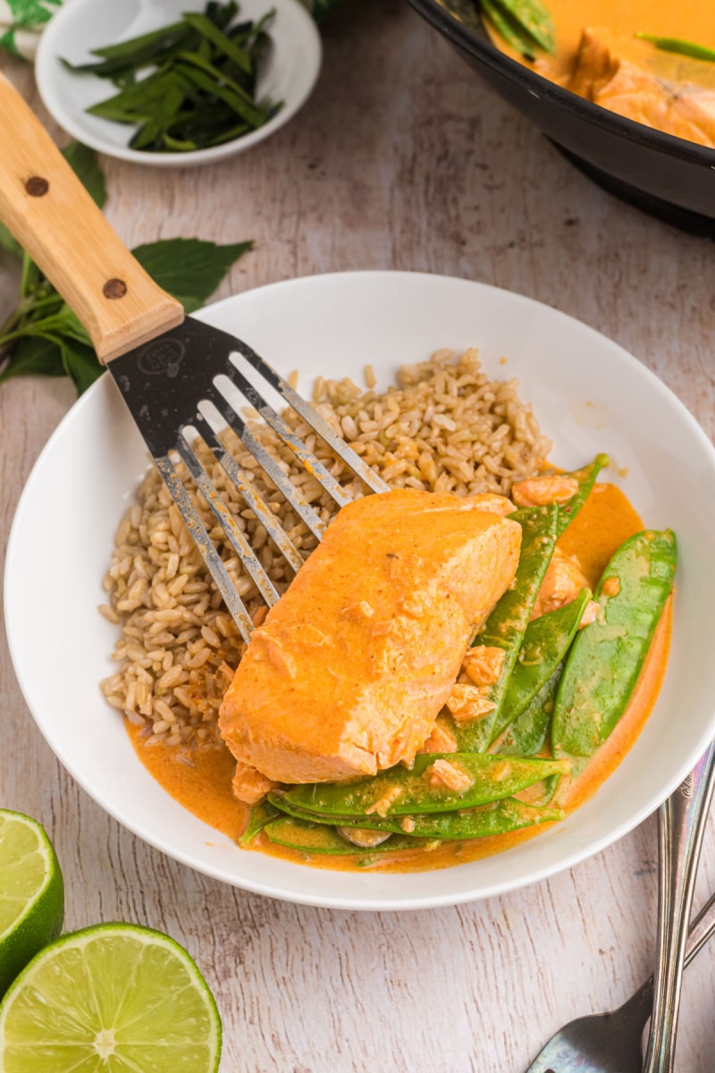 spooning salmon onto dinner plate