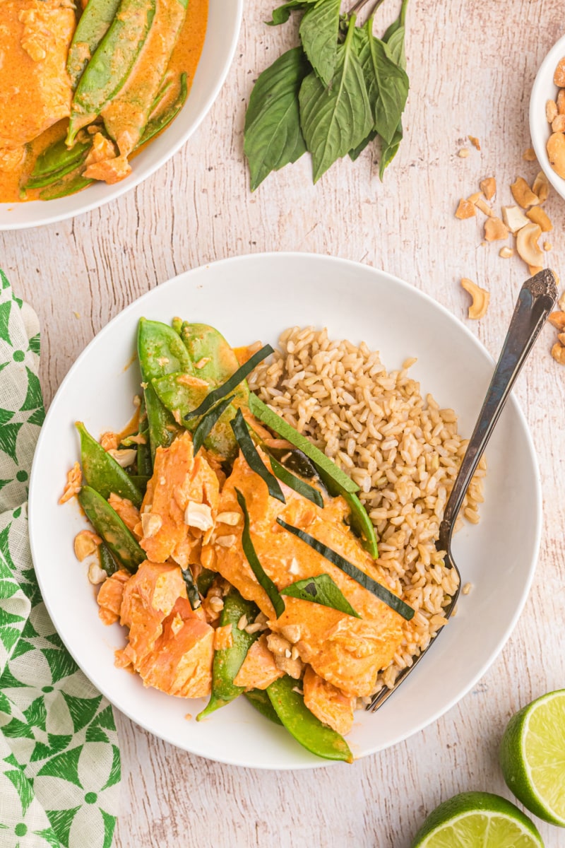 thai coconut red curry salmon on plate with rice