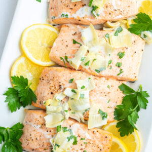 air fryer salmon fillets topped with chardonnay butter sauce and lemon slices