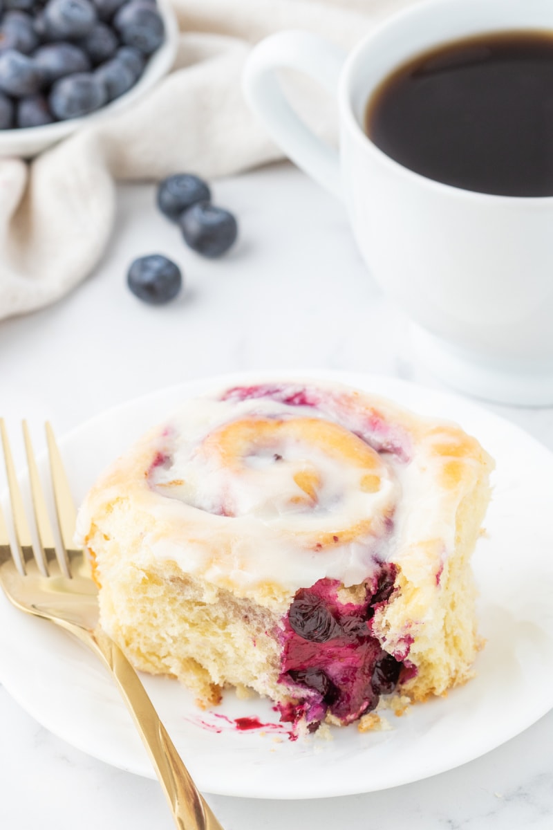 blueberry sweet roll on a plate with a fork