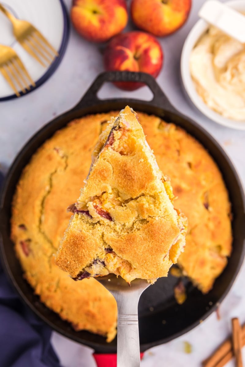 slice of peach cornbread above cast iron cornbread