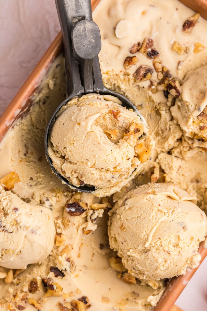 scoops of maple walnut ice cream on top of tub of ice cream