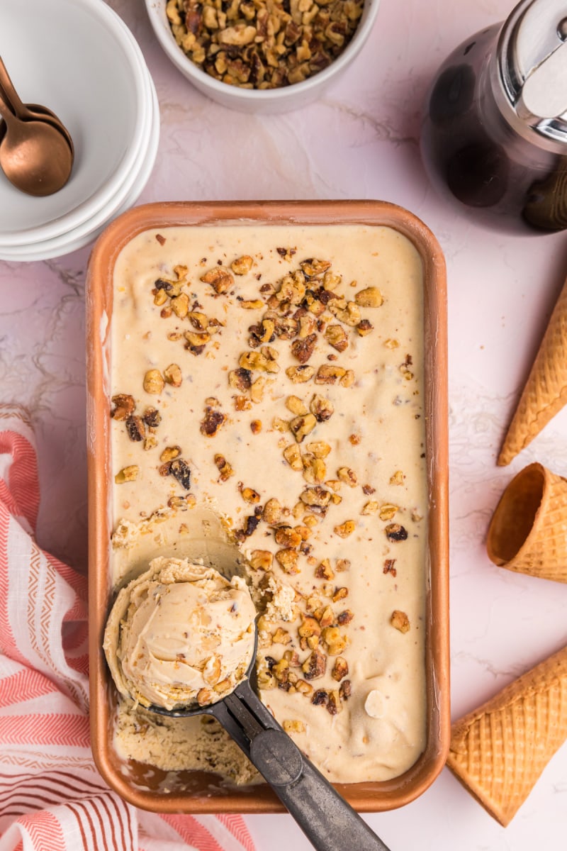 dish of maple walnut ice cream with ice cream scoop in it