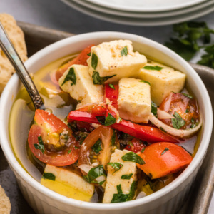 bowl of marinated feta with cherry tomatoes