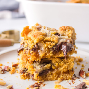 two peanut butter fudge bars stacked on plate