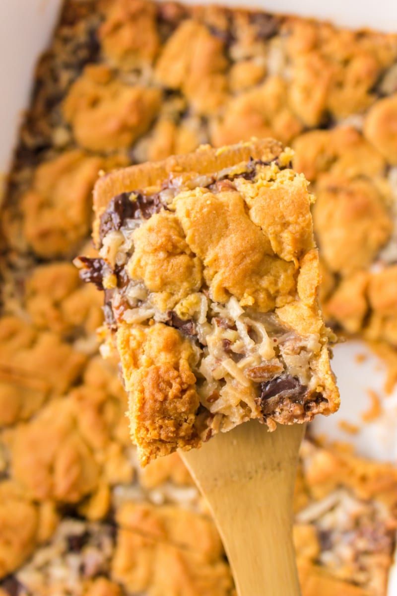 spatula holding up a peanut butter fudge bar over pan of bars