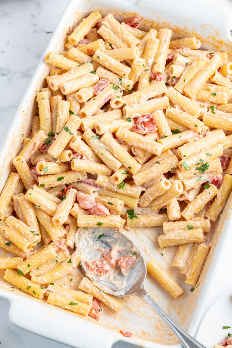 3 cheese baked ziti in a casserole dish with serving taken out