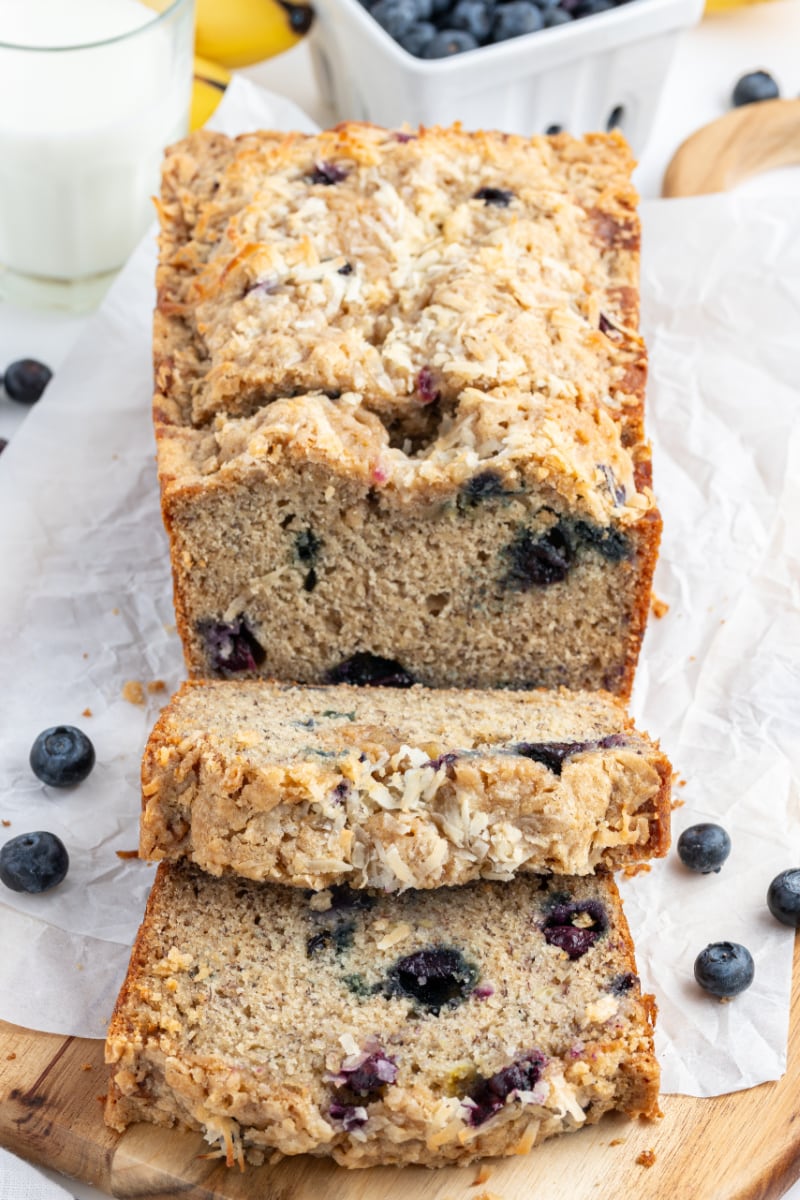 loaf of blueberry coconut banana bread cut into slices